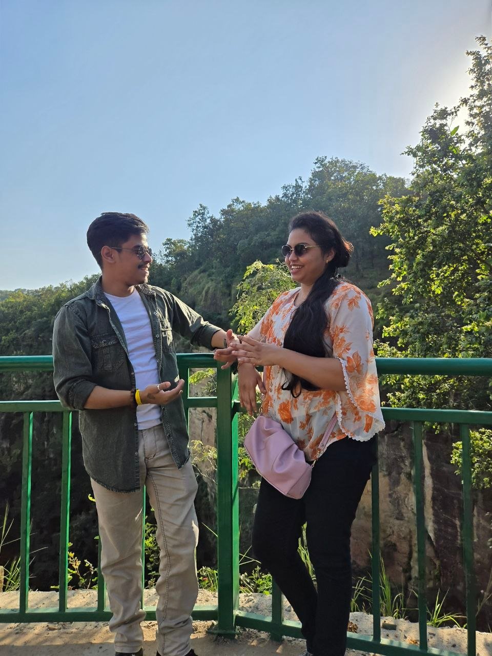 Laughing by the railing above the valley